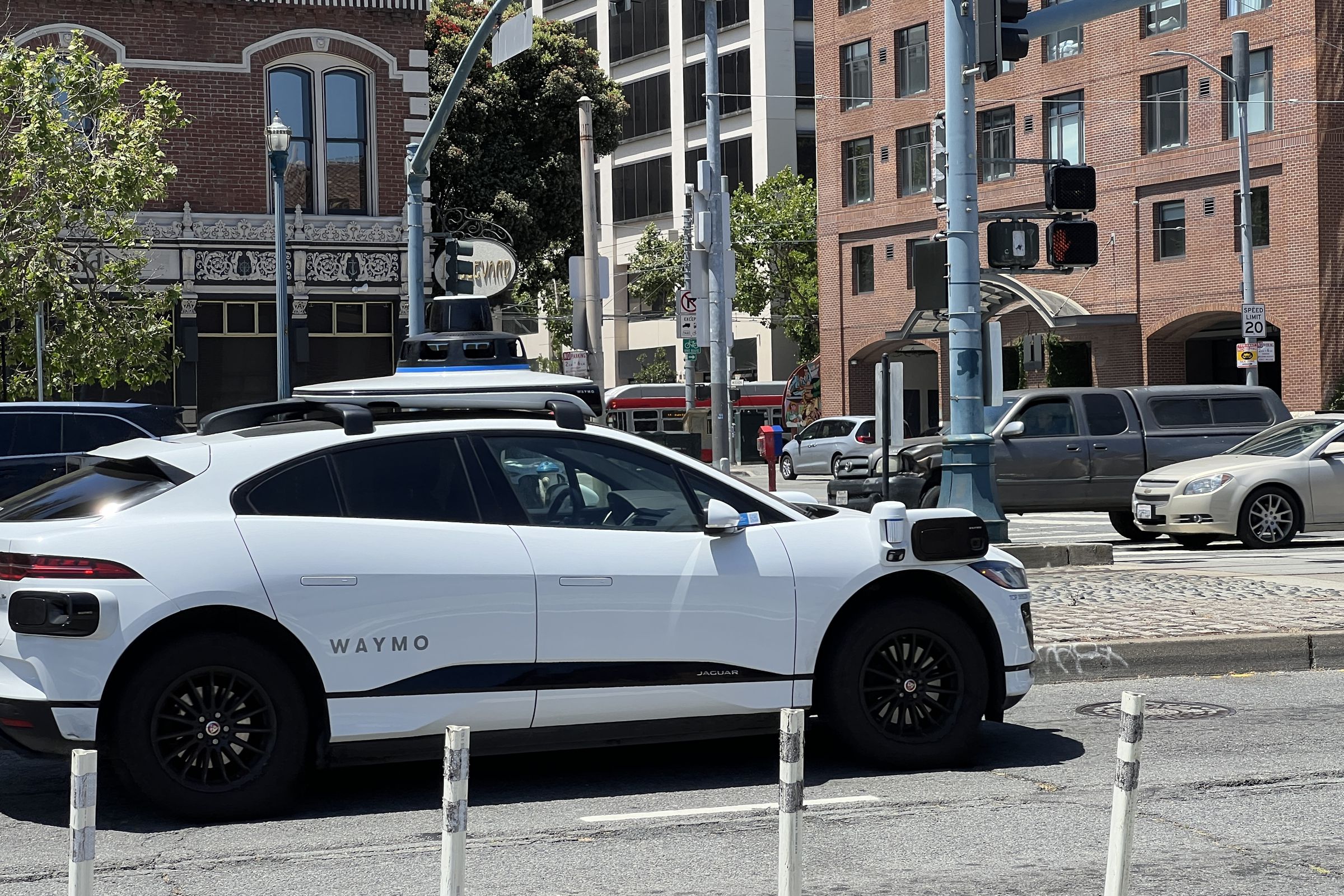 A Waymo car driving on a street.