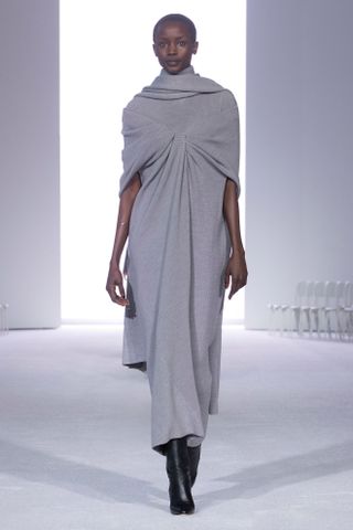 Photo of model on Brandon Maxwell Fall/Winter 2024 runway wearing knitted gray dress.