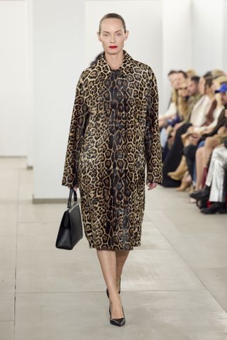 Model at Michael Kors Fall/Winter 2024 wearing leopard print coat.