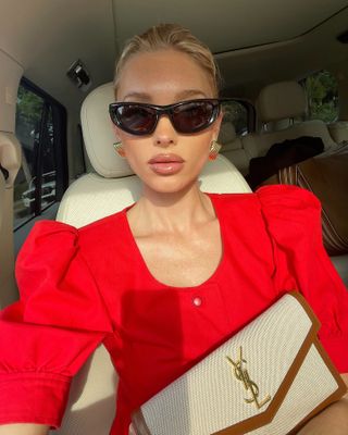 Woman wearing a cherry red top.