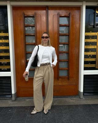 @holliemercedes wearing pointed-toe flats and wide-leg trousers