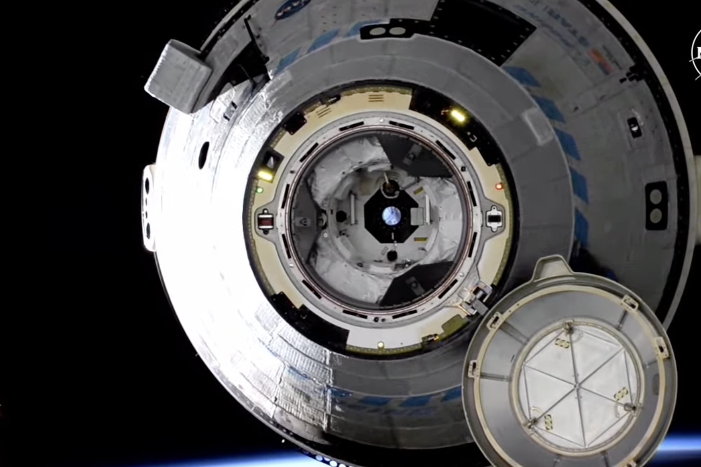 A picture of Starliner taken as it slowly floats away from the International Space Station just after undocking.