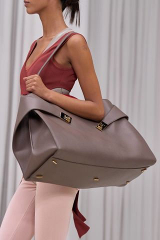 Ferragamo model wearing big leather. hug bag