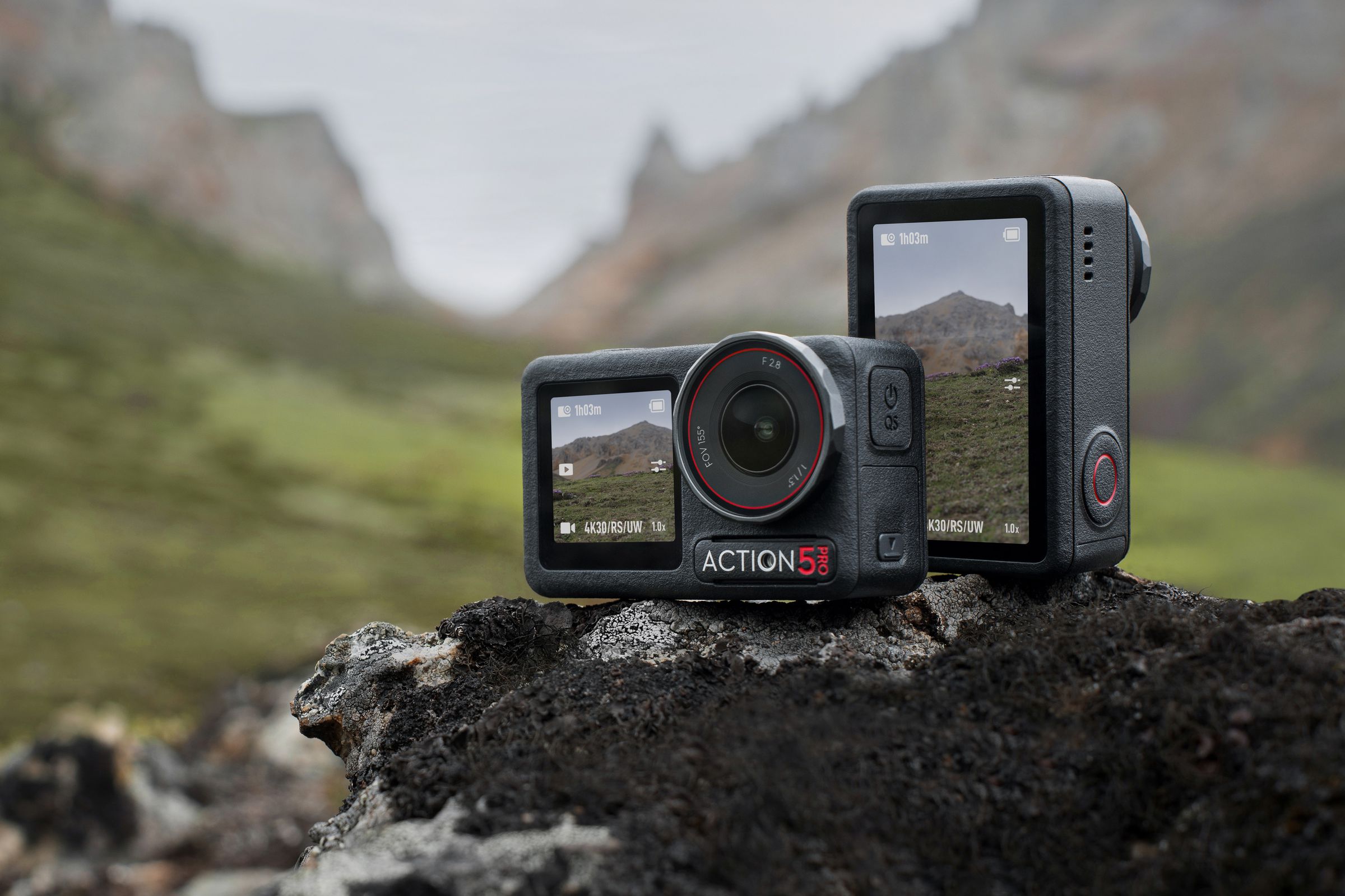 Two of DJi’s latest action cameras perched on a rock to show both the front and rear OLED displays and both landscape and portrait shooting.