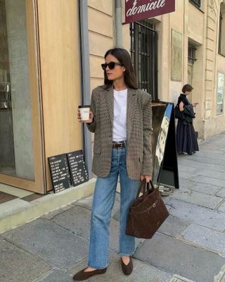 woman in jeans, blazer, brown bag and ballet flats