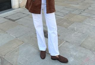 woman in white jeans and brown loafers