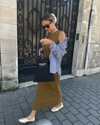 French woman wearing a maxi dress and white ballet flats.