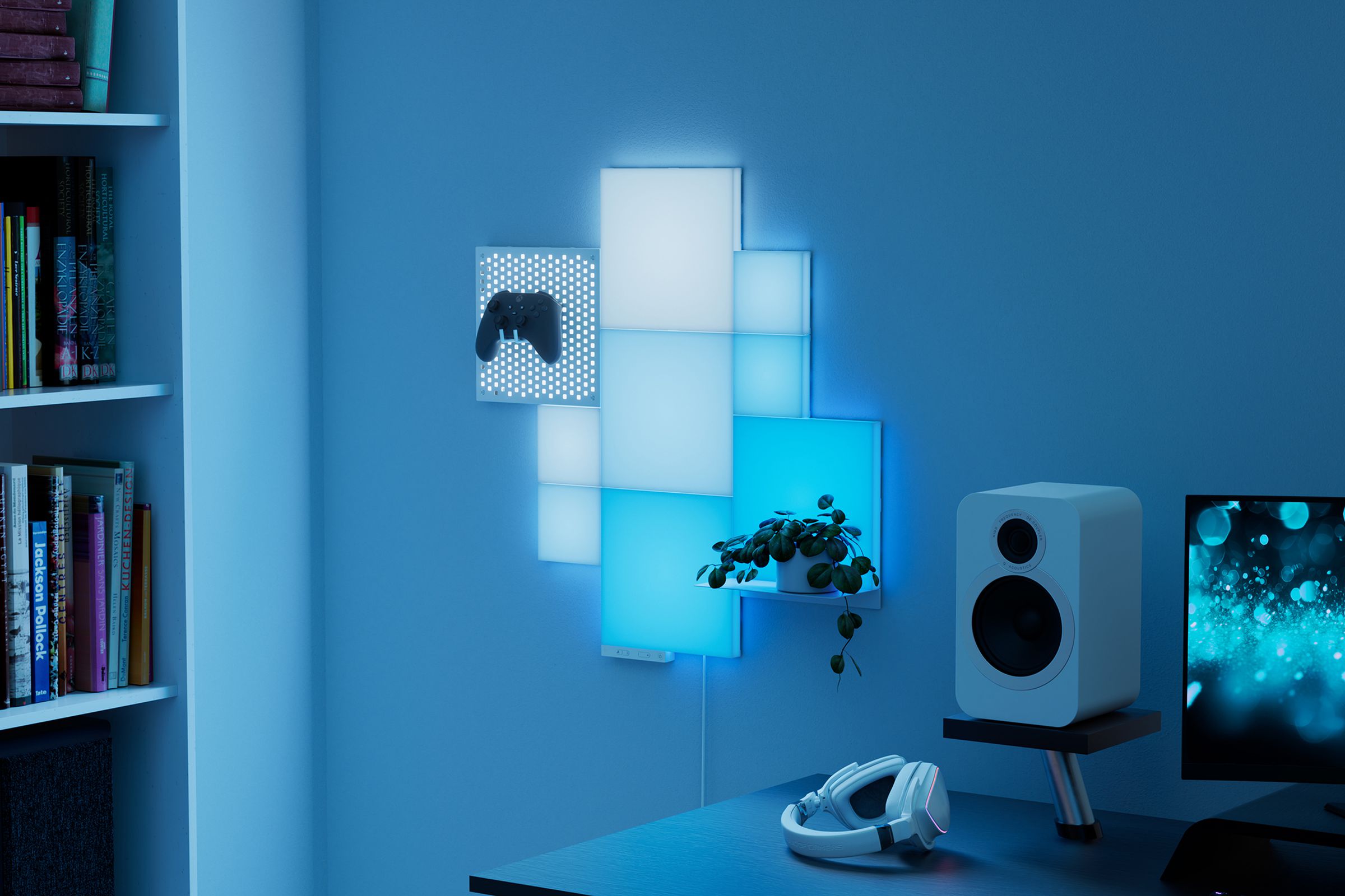 Press shot of nine light-up square wall panels, in varying shades of white and blue, with a plant and an Xbox controller hanging from two of them. 