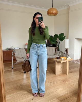 Green top and blue jeans on Emily