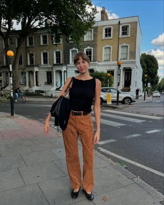 Influencer wears suede trousers.