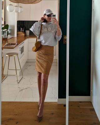 Influencer wears a suede skirt.