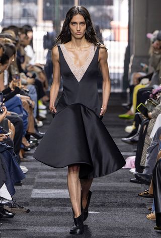 a model on the JW Anderson spring 2025 runway wearing a structural drop waist dress