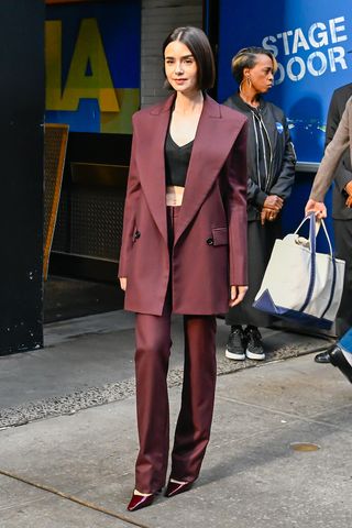 Lily Collins wearing a burgundy suit