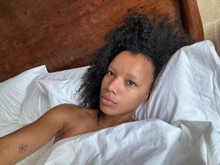 Fia taking a selfie in bed with glowing skin