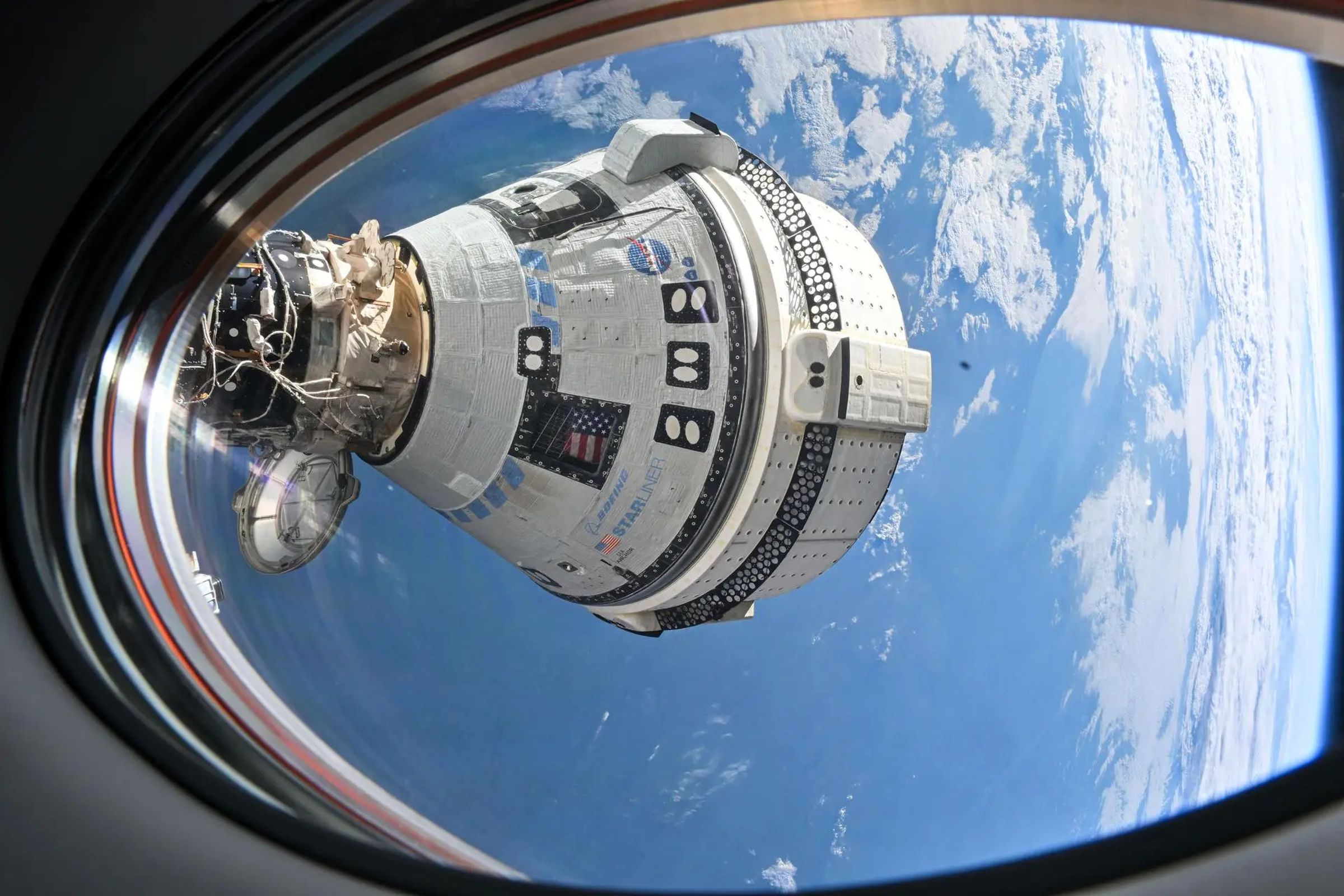 A photo showing the Starliner spacecraft docked at the ISS