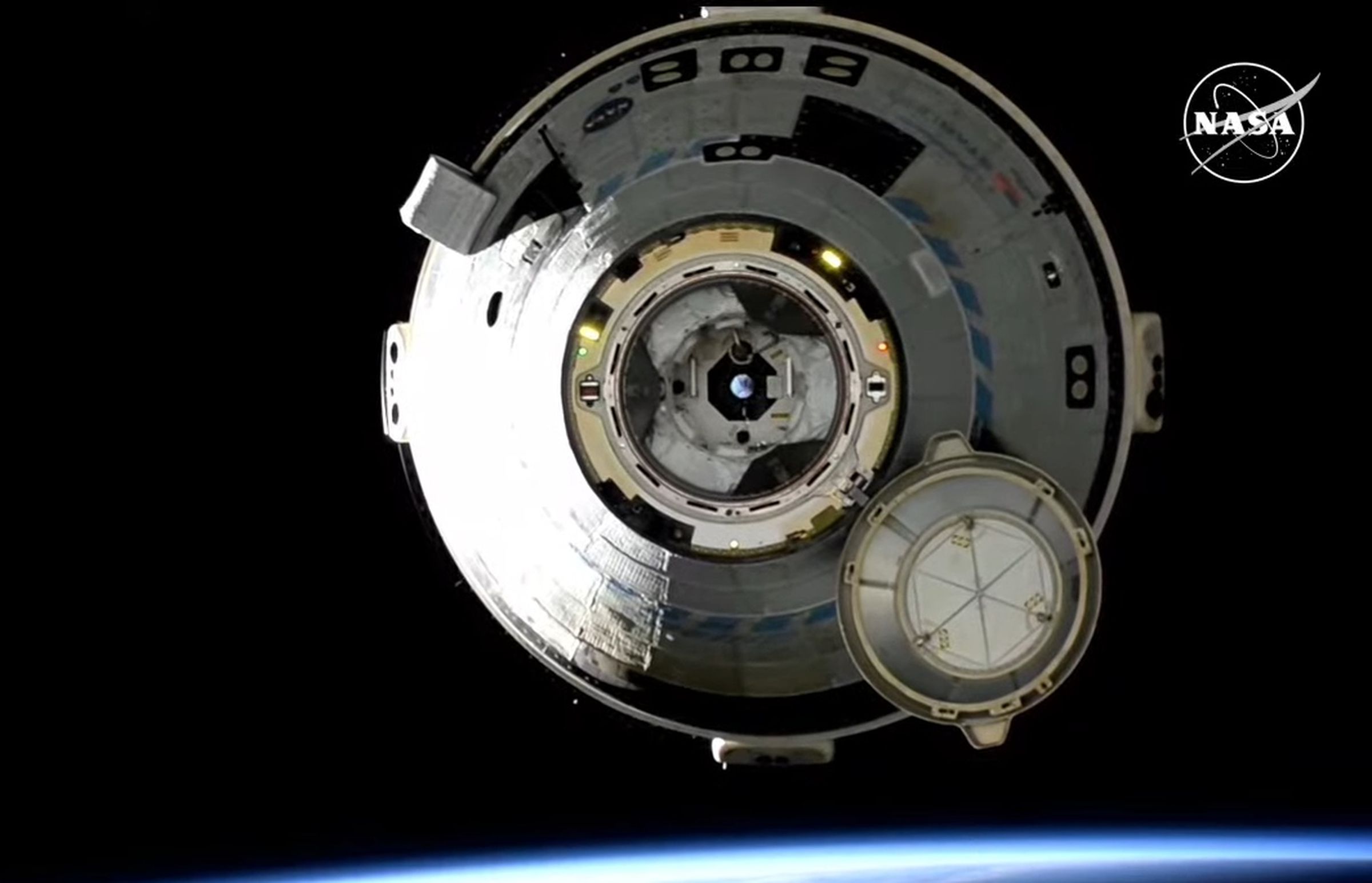 Still image from the live stream of Starliner’s autonomous undocking showing the spacecraft as it slowly separated from the ISS.