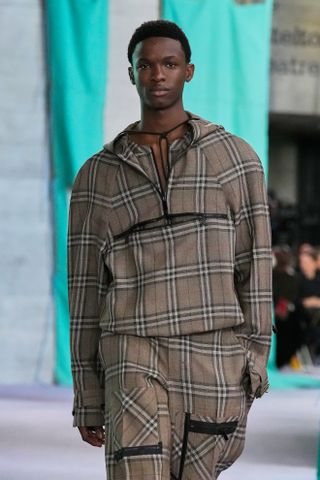 Burberry S/S 25 show, a male wears a check-print half-zip pullover