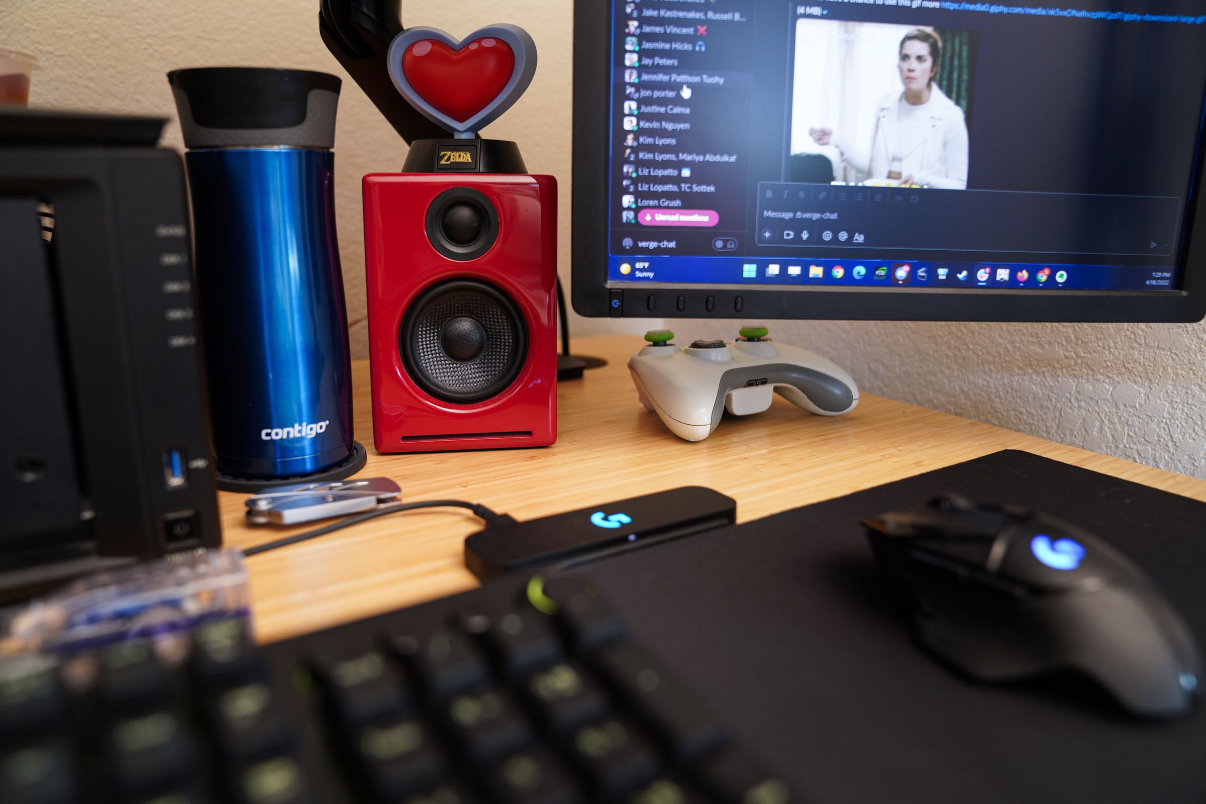 Desktop with red speaker and red Legend of Zelda heart container on top of it.