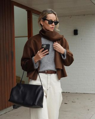 Woman wearing a brown scarf coat.