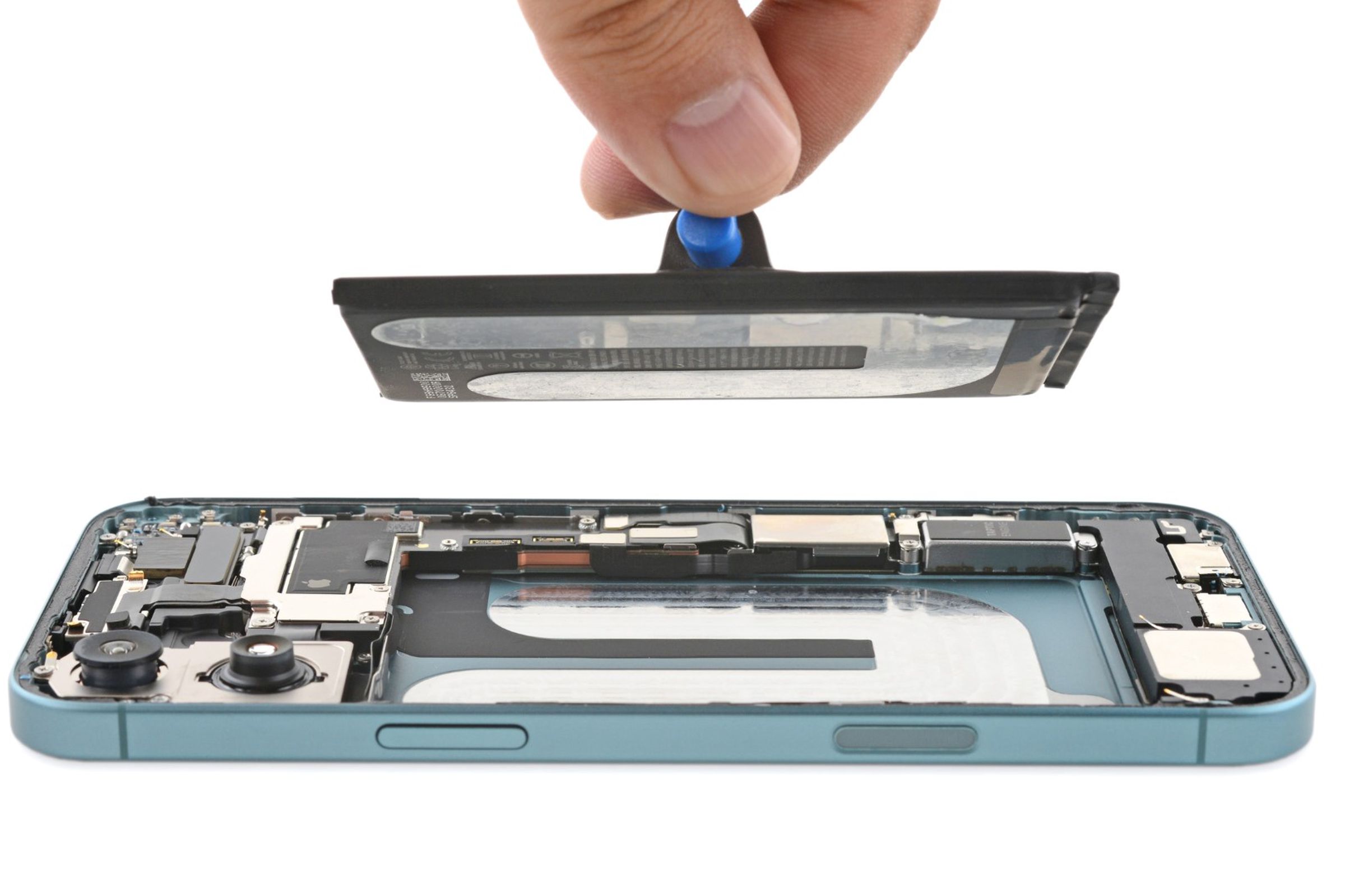 A picture of a partially deconstructed iPhone 16, with one side removed and the battery being lifted from it.