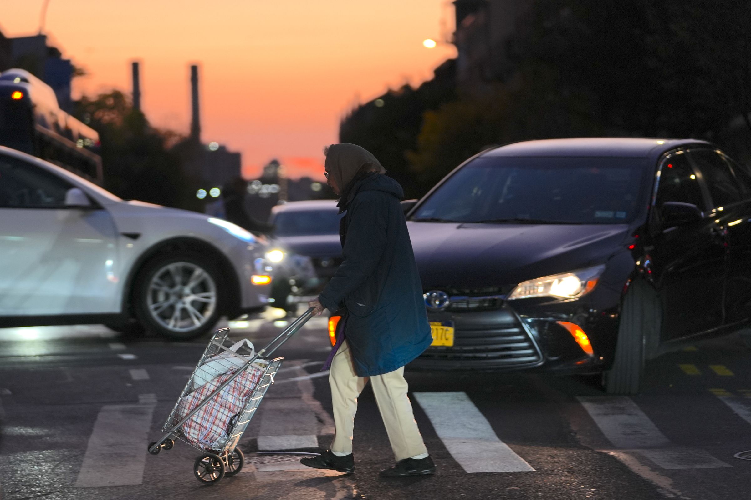 Cars and pedestrians in NYC at night