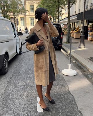 Sylvie Mus wearing a tan suede coat and brown suede Manolo Blahnik mules.