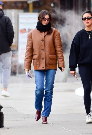 Emily Ratajkowski wears burgundy boots.