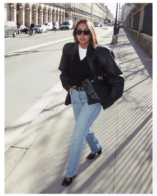 Hanna MW wearing a leather jacket and jeans in Copenhagen