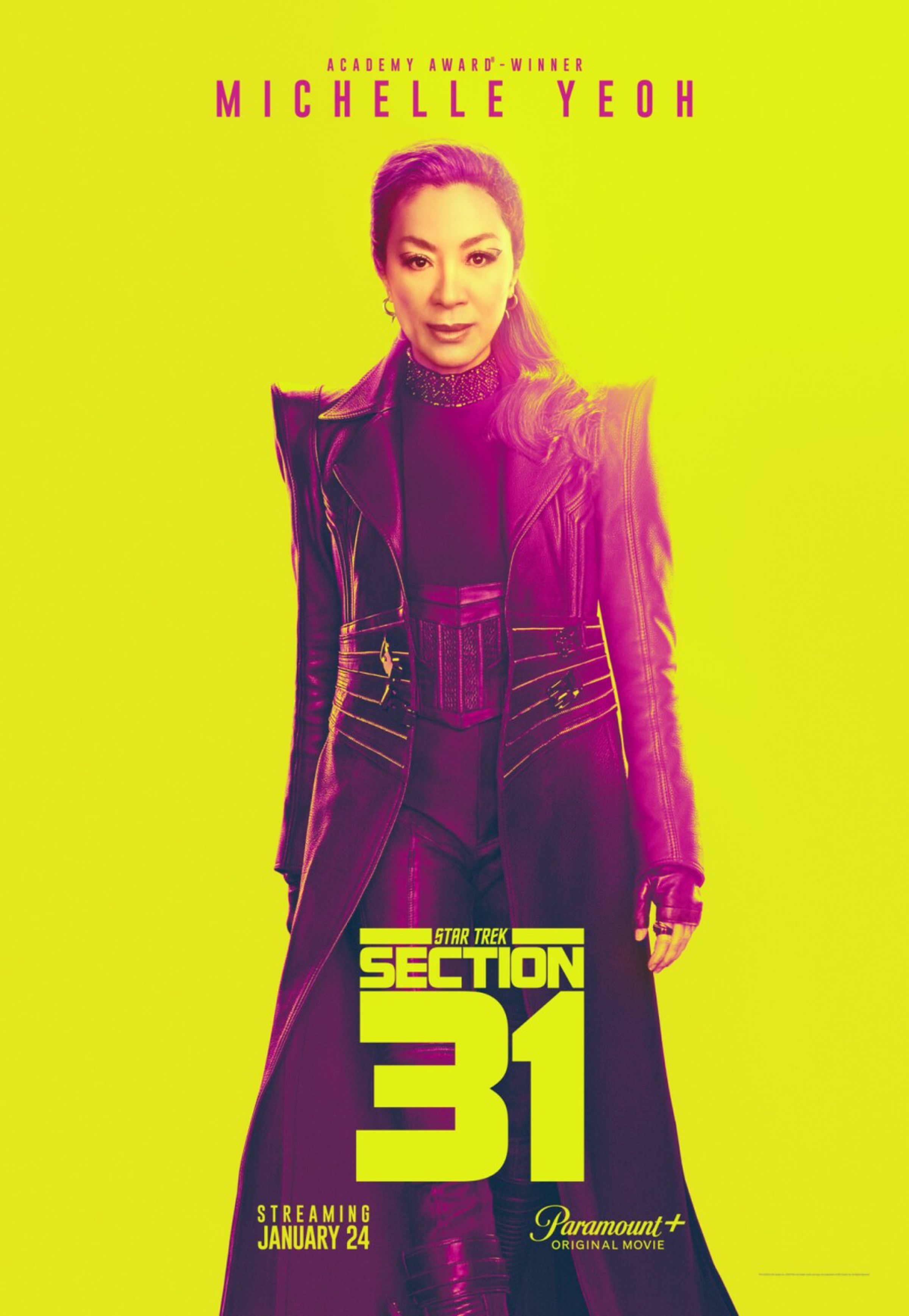 Michelle Yeoh as Georgiou, standing in front of a yellow background with the title “Star Trek: Section 31” stamped in front of her in the lower section of the screen.