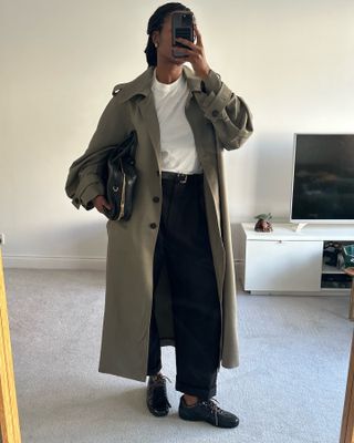 Influencer wears a khaki trench coat.