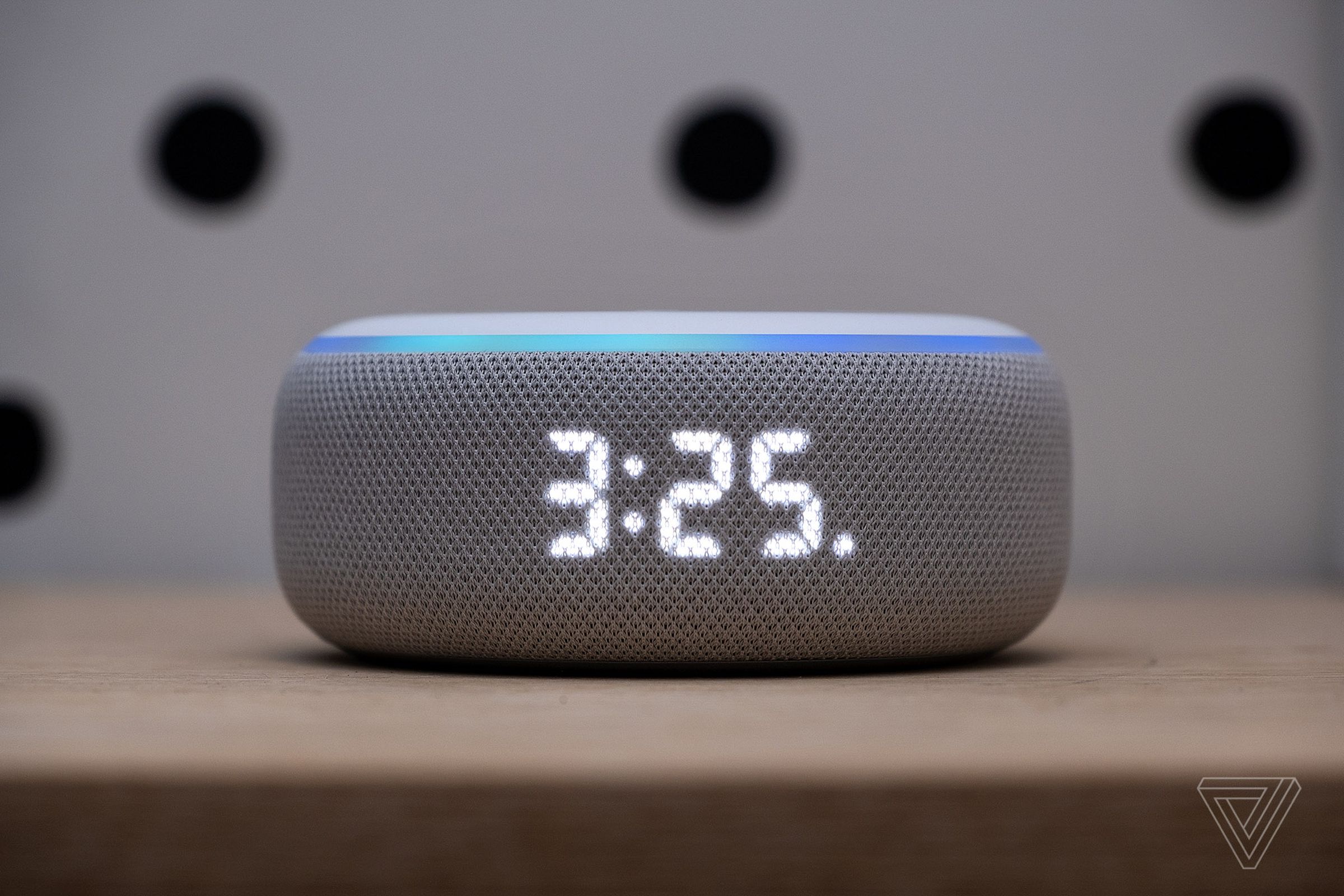 A close-up of the dot matrix screen, hidden behind a layer of fabric, on the original Amazon Echo Dot with Clock.