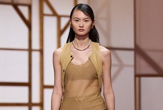 an Hermes model walks the spring/summer 2025 runway