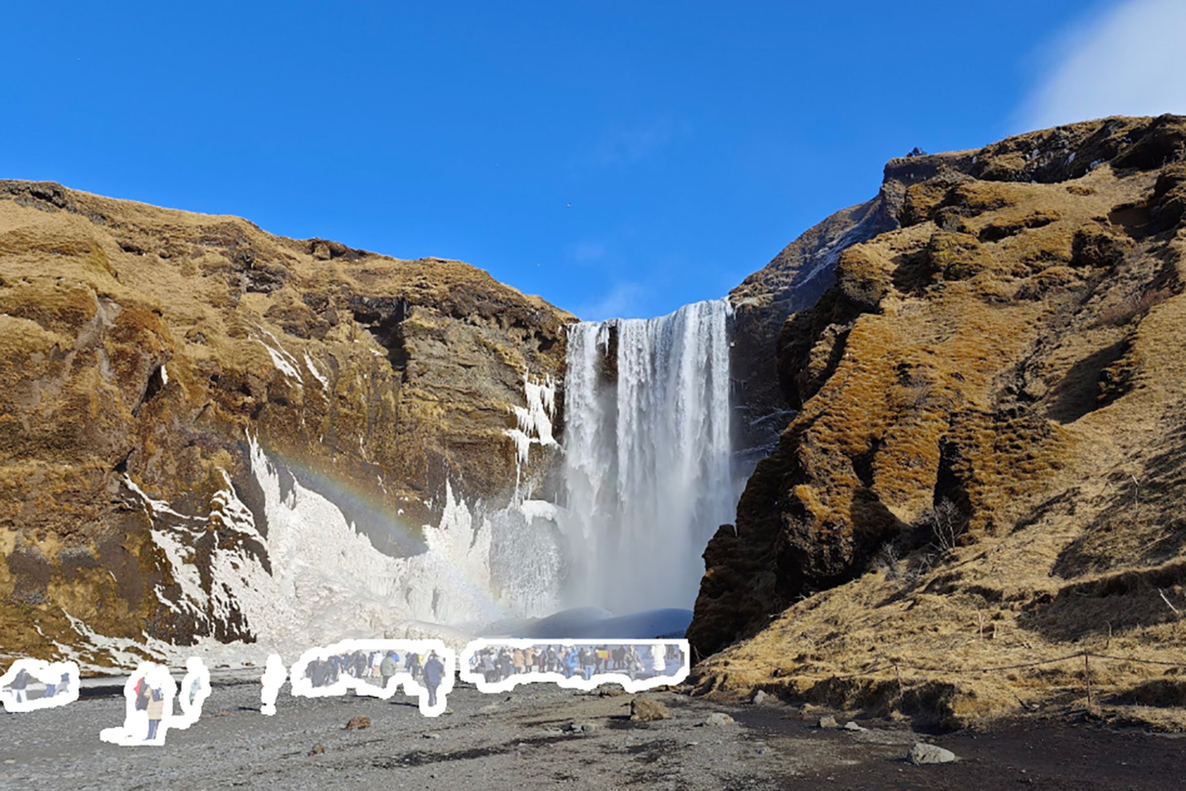 Photo of a waterfall with crowds of people highlighted using Google Photos’ Magic Editor tool.