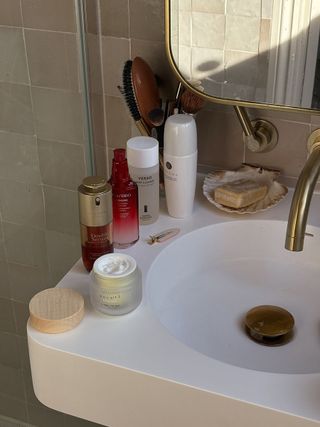 Emma Hoareau's bathroom counter featuring Tatcha, Verso, Clarins, and Shiseido products.