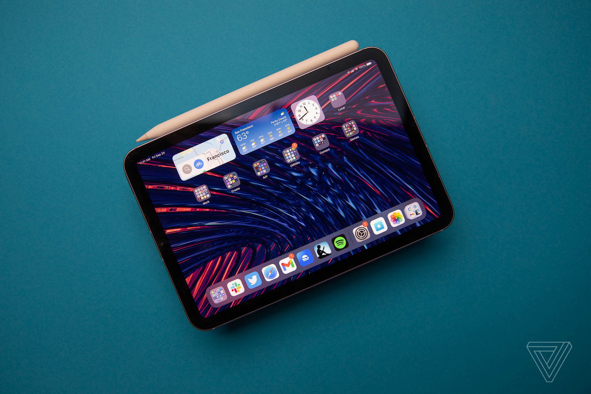 Photo of the 2021 iPad Mini with attached second-generation Apple Pencil on blue background