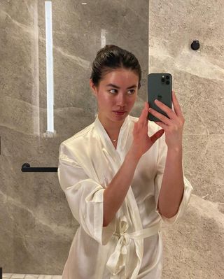 Sasha Mei wearing a silk robe after applying a Noble Panacea face mask