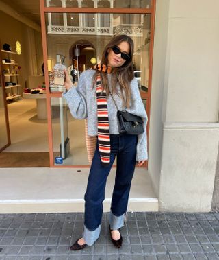 woman in gray sweater, scarf and jeans