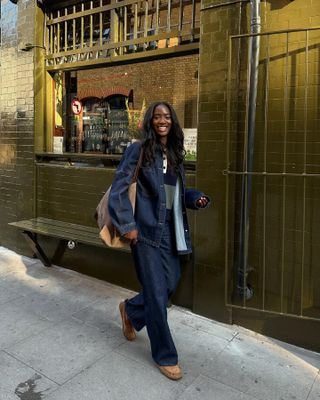 Woman wears dark indigo jeans with a matching jacket