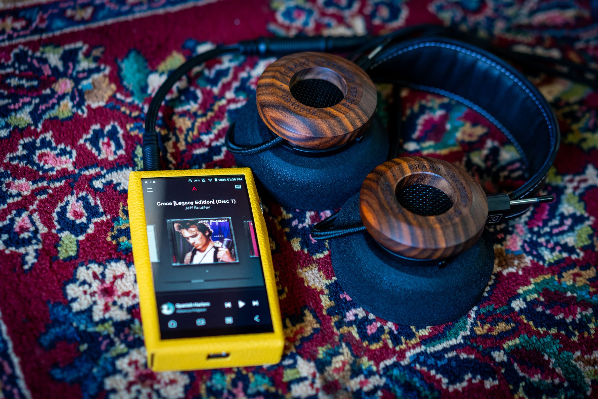 Image of Astell &amp; Kern SP3000T media player, an angular portable media player with silver edges and a red tube amp on the back. Some images show a yellow calfskin leather case.