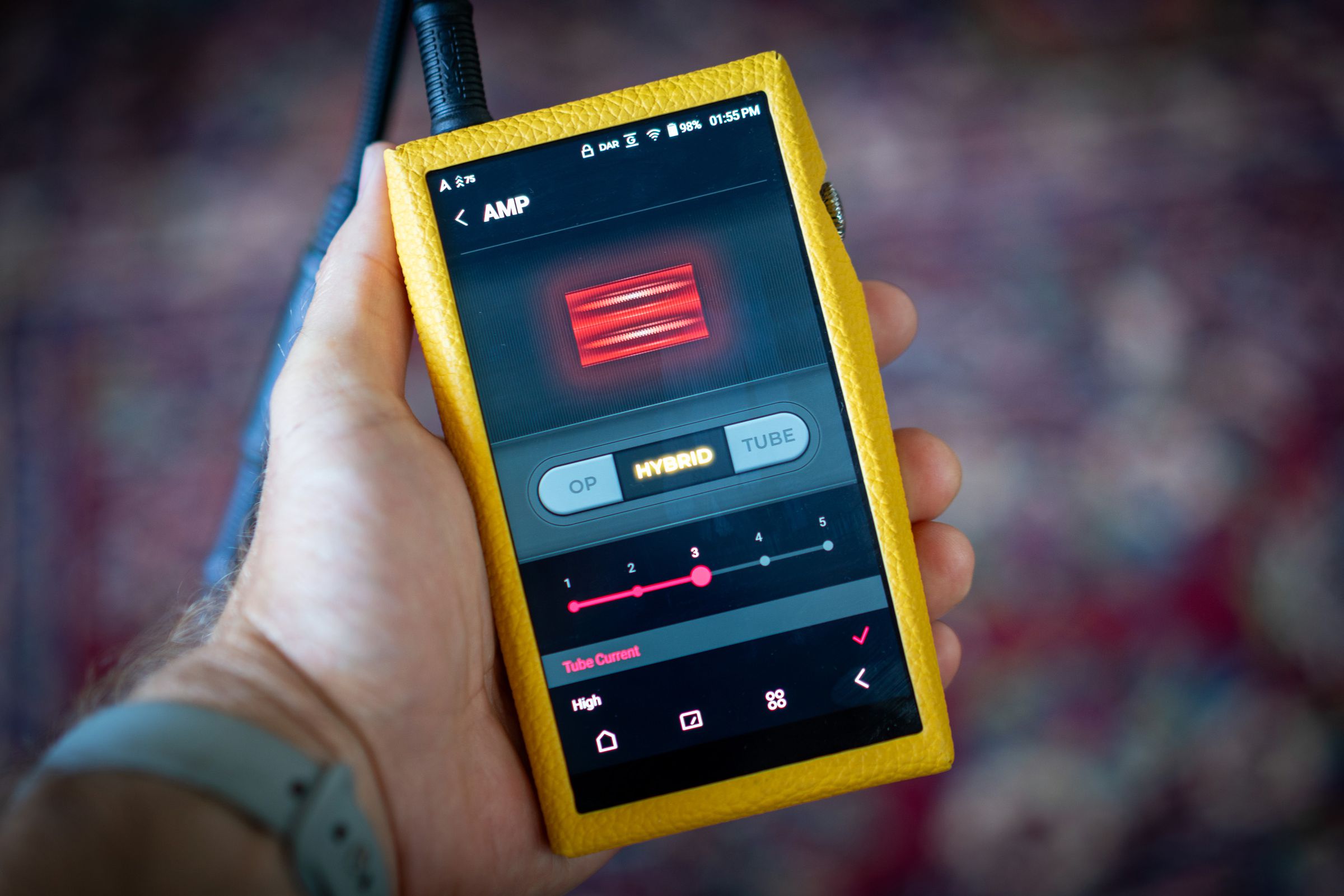 Image of Astell &amp; Kern SP3000T media player, an angular portable media player with silver edges and a red tube amp on the back. Some images show a yellow calfskin leather case.