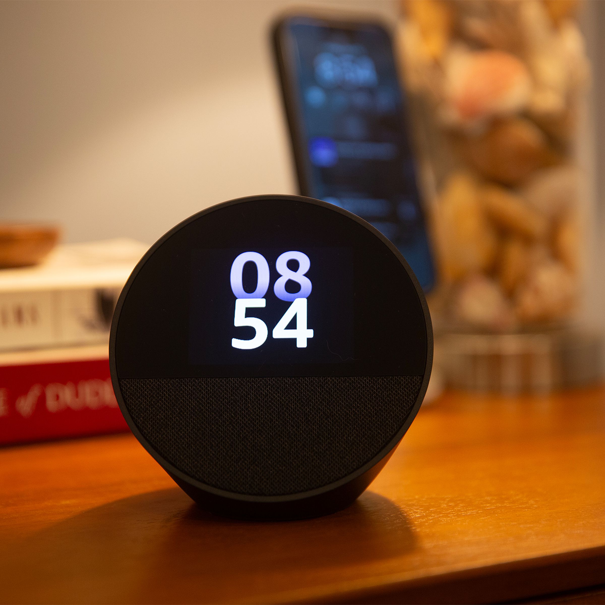 Photo of an Echo Spot sitting on a nightstand.