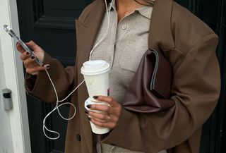 woman in stylish clothes looking at phone.