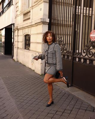 French woman wearing a skirt and block-heel pumps