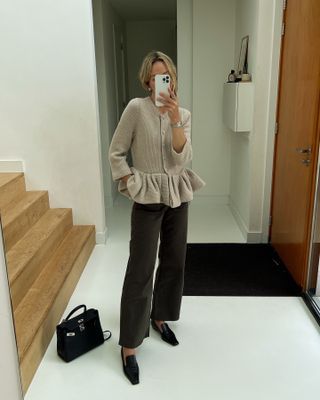 Influencer wearing a cardigan, trousers, and pointed-toe loafers