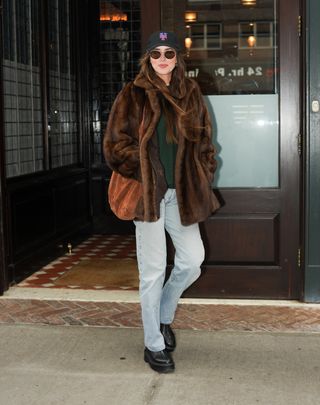 Dakota Johnson wearing a brown coat in NYC