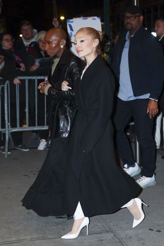 Ariana Grande wearing a black maxi coat with white pumps in NYC