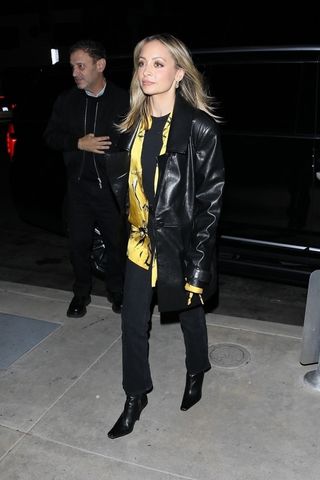 Nicole Richie wearing a black leather jacket and black jeans