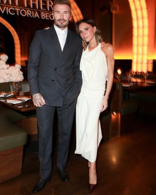 Victoria Beckham wears a draped dress.