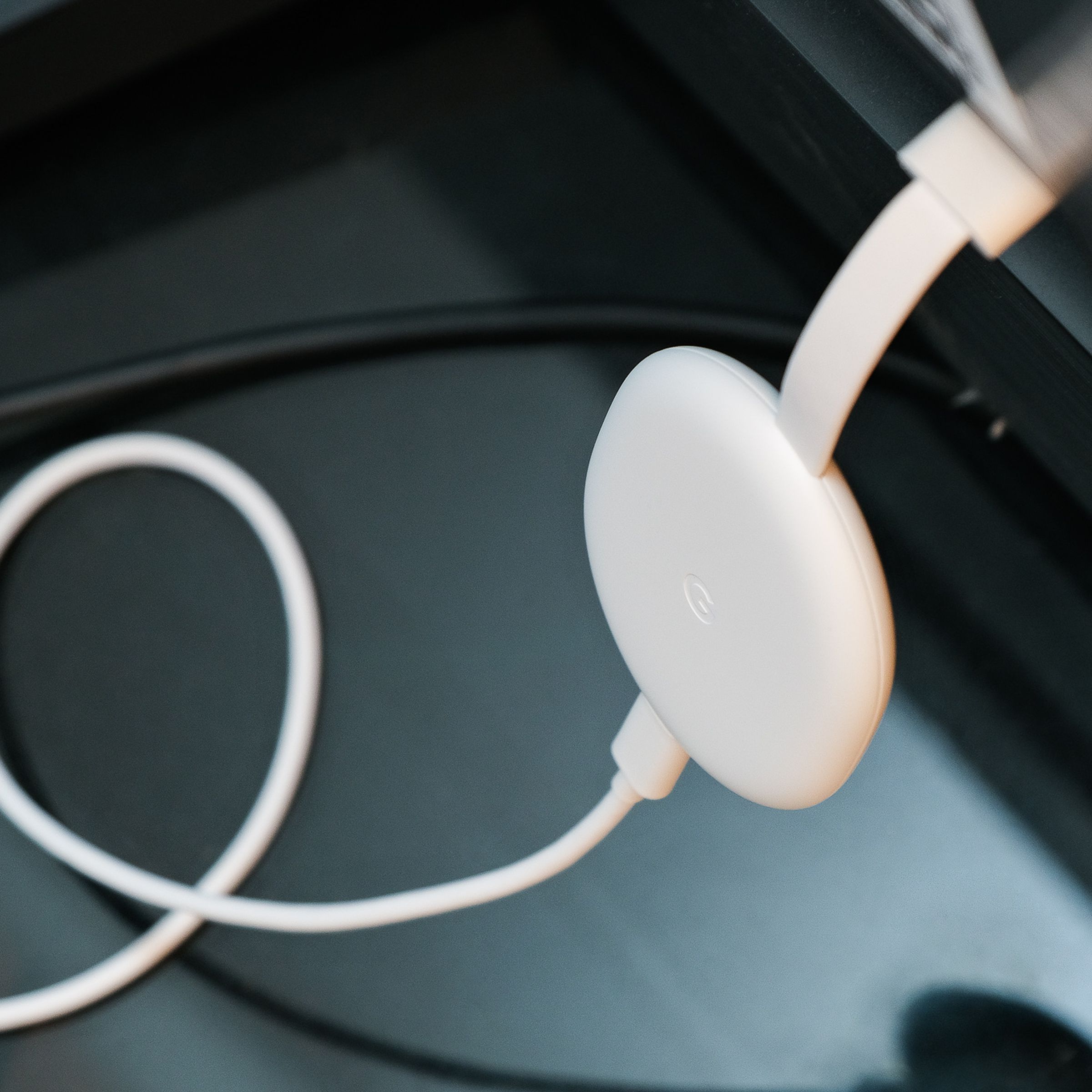 An image of the Google Chromecast, the best streaming stick of 2021 for most people, resting on a soundbar.