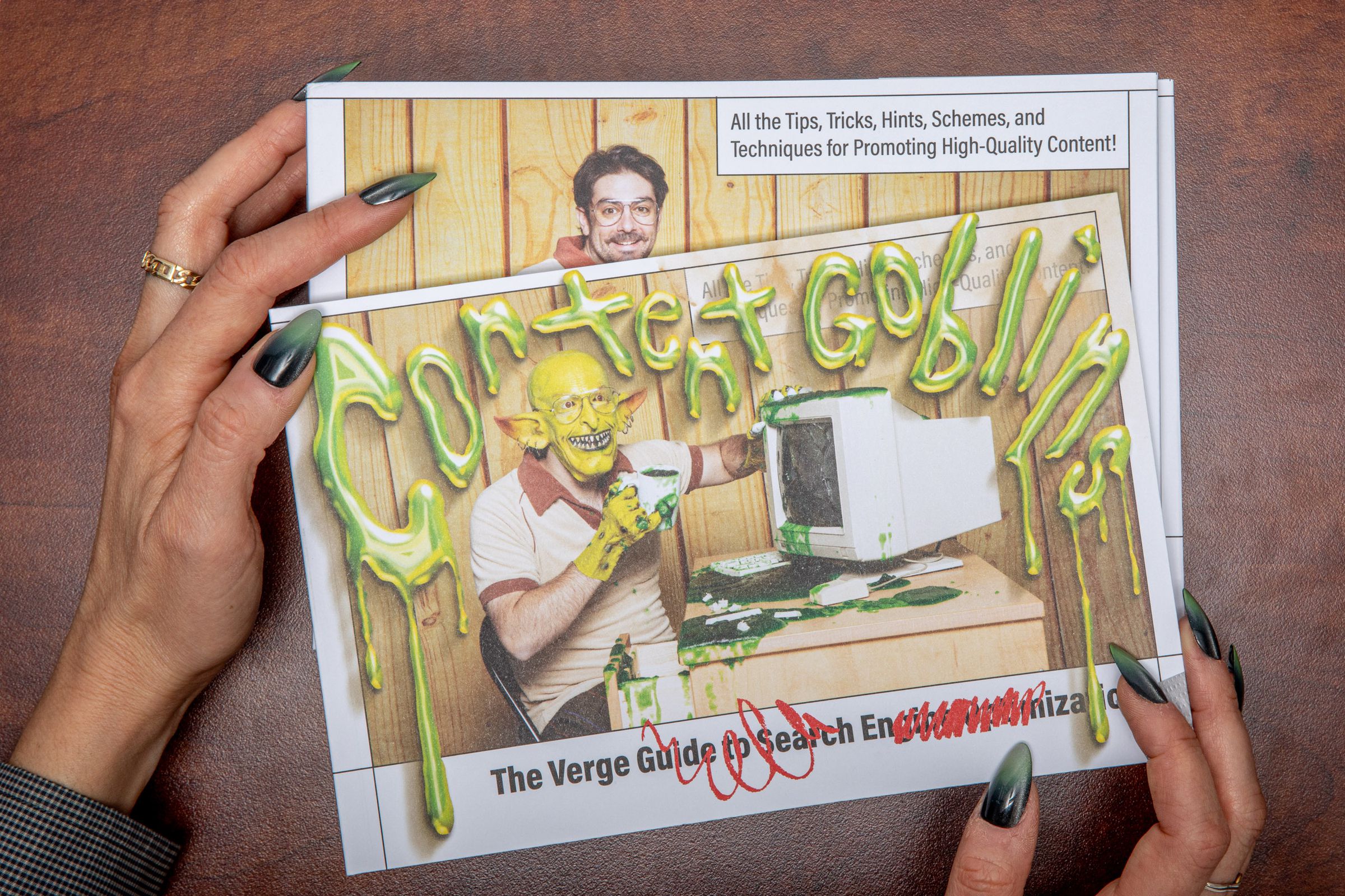 Two hands holding two postcards, the front of which shows a goblin at an old-fashioned computer and reads: Content Goblins.